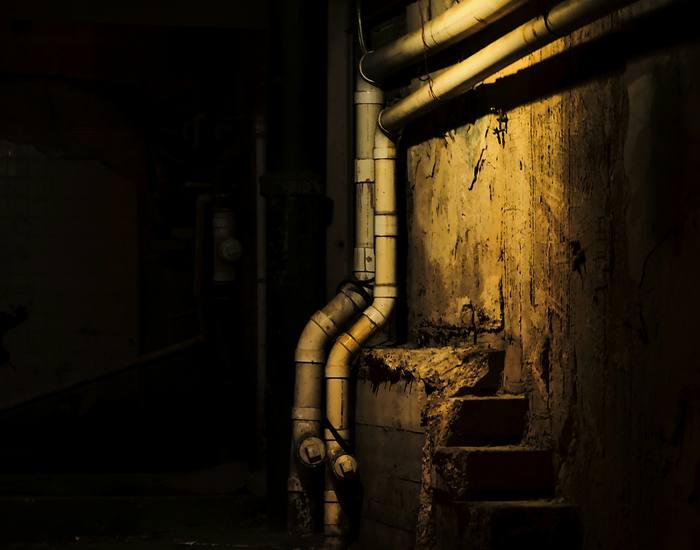 Basement pipes and utilities in a concrete space